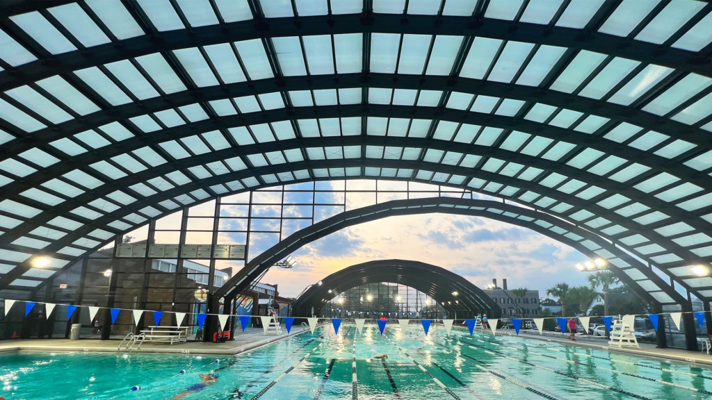 DynaDome | An arched retractable enclosure housing a swimming pool.