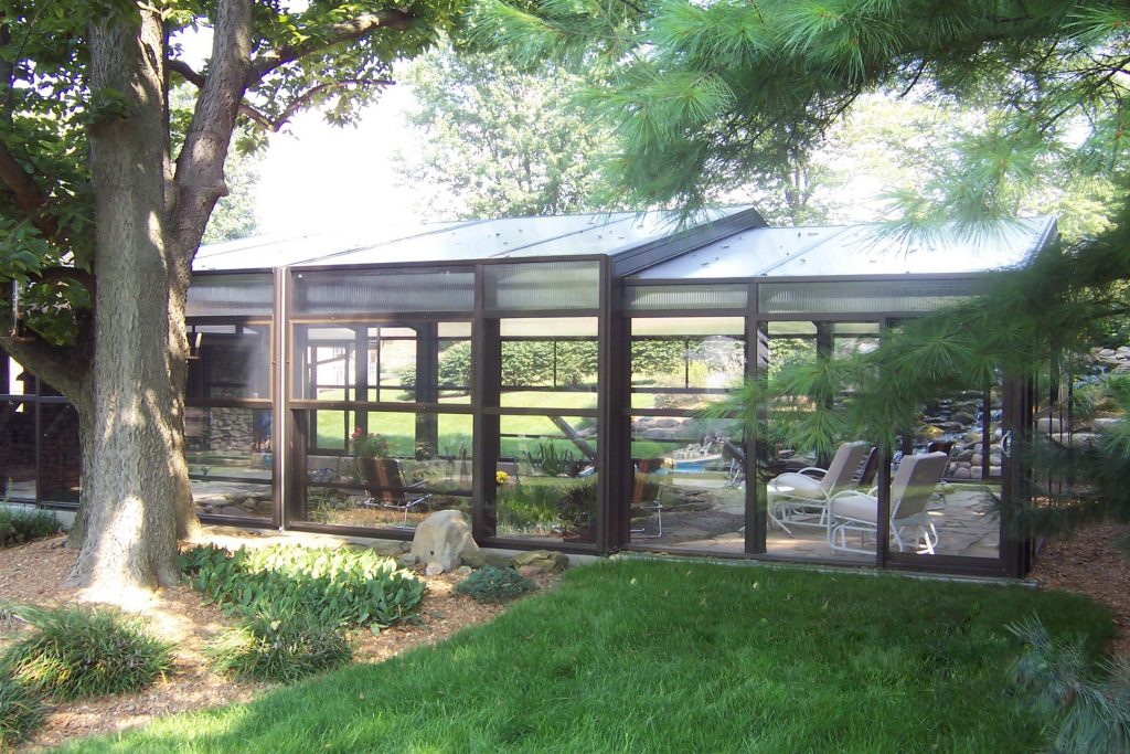 DynaDome | A retractable enclosure surrounds a large tree in the yard.