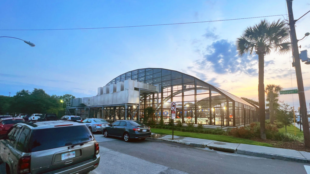 DynaDome | A retractable enclosure with cars parked in front of it.