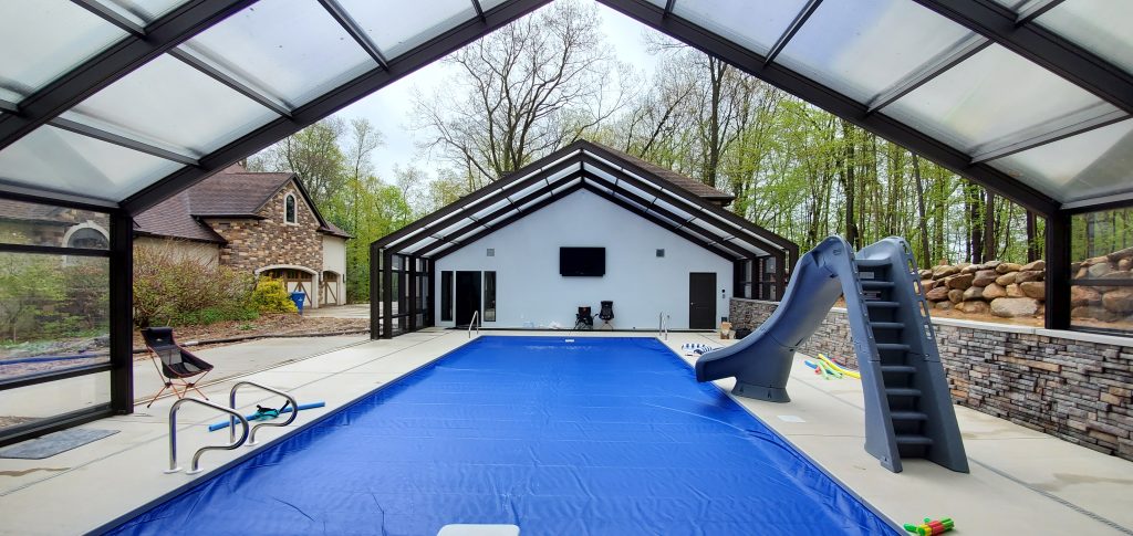 DynaDome | A swimming pool in a house with a retractable enclosure.
