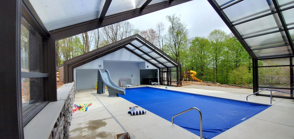 DynaDome | A swimming pool in a house with a retractable enclosure.