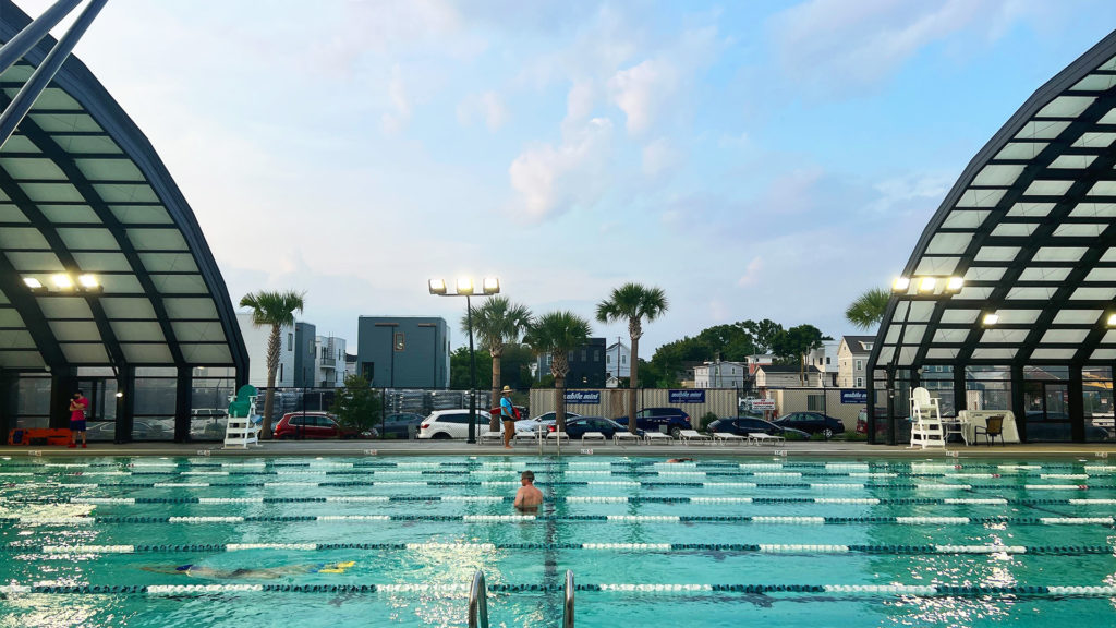 DynaDome | A person is swimming in a retractable indoor swimming pool.