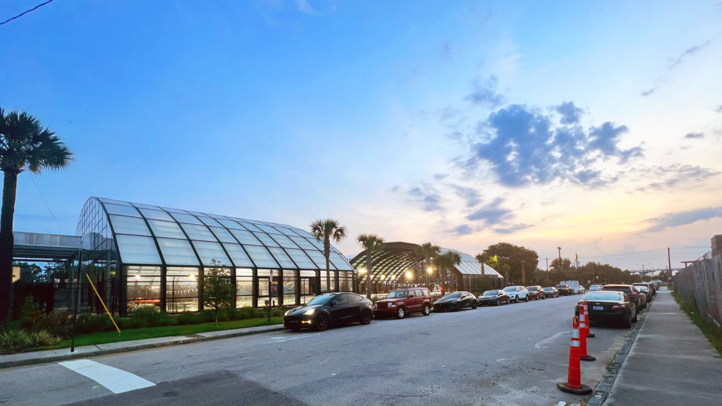 DynaDome | A street with retractable enclosures in front of a greenhouse.