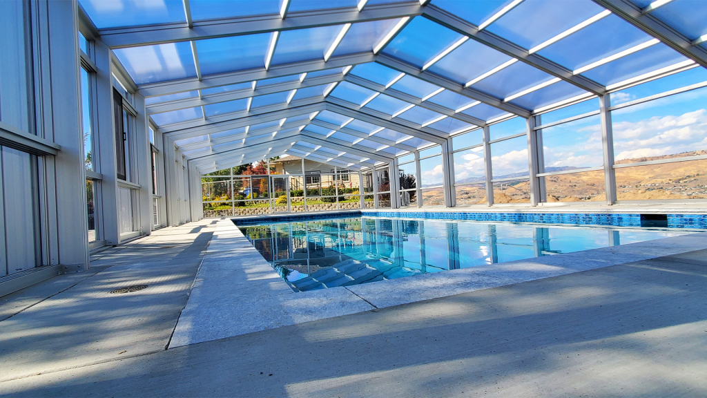 DynaDome | An indoor pool with a retractable glass enclosure.