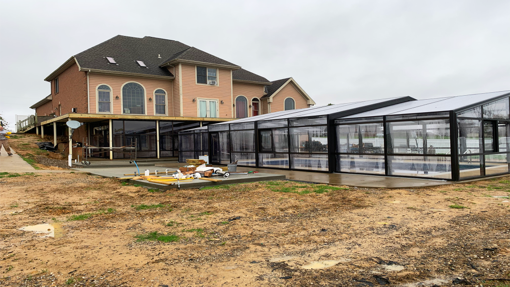 DynaDome | A house under construction with a retractable glass enclosure.