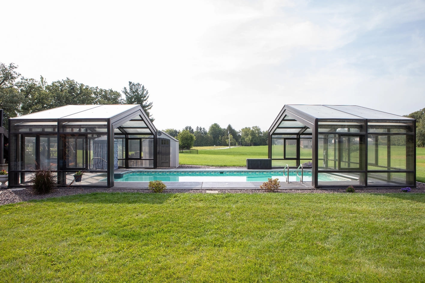 DynaDome | A glass enclosure with a pool in the Home Landing backyard.
