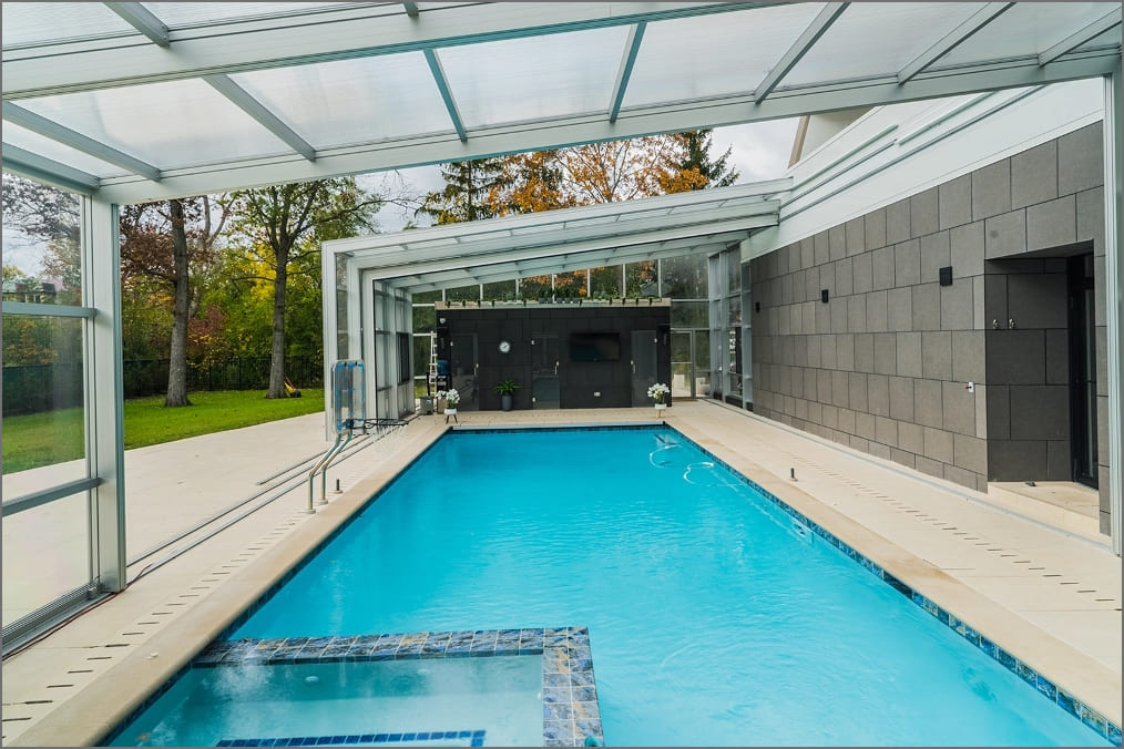 DynaDome | A glass enclosed swimming pool in a home landing.