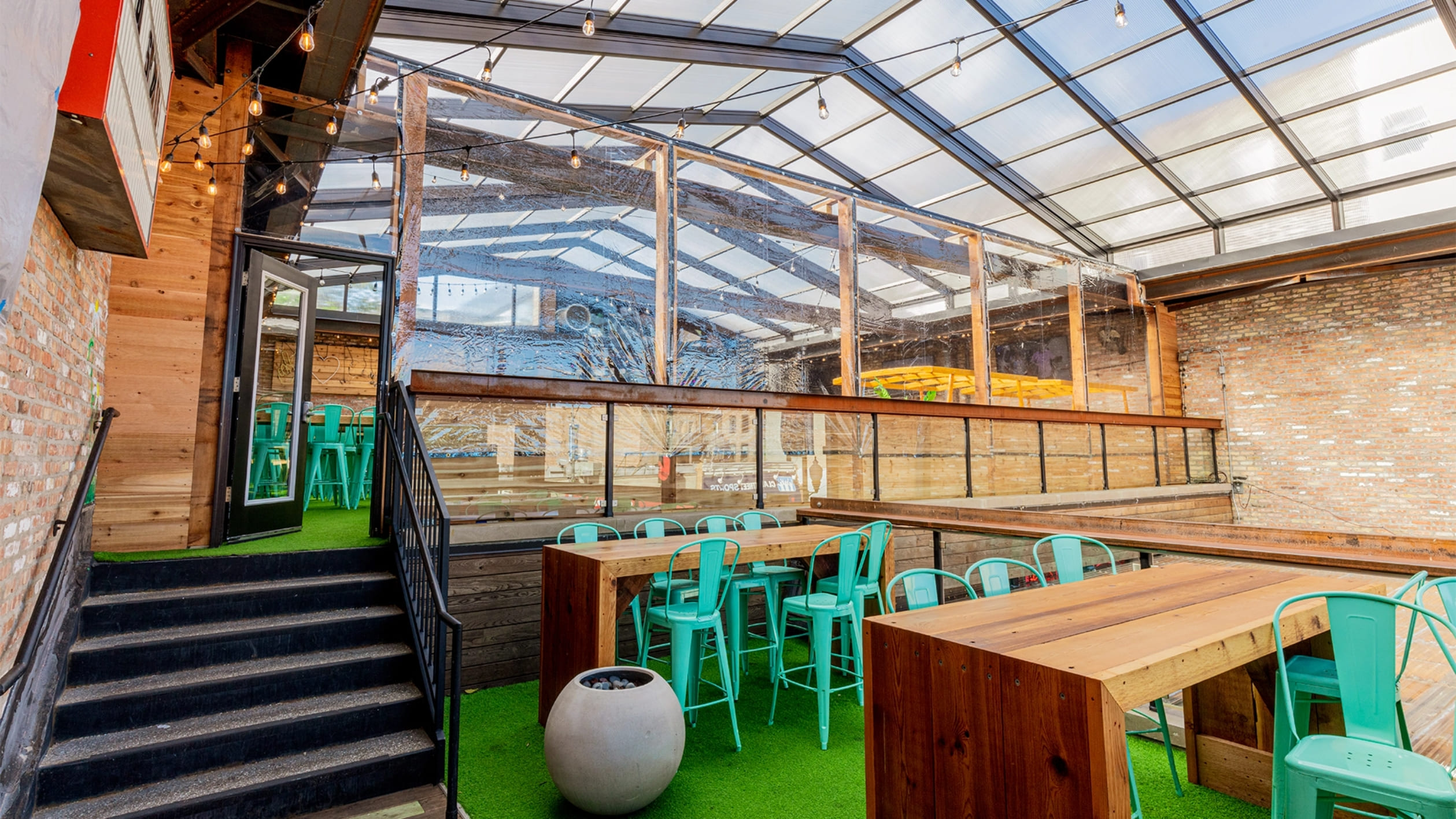 DynaDome | A restaurant with a glass roof and green chairs, creating a cozy and inviting dining experience.